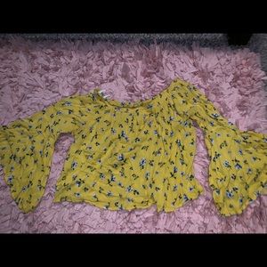 Yellow crop top with blue flowers.